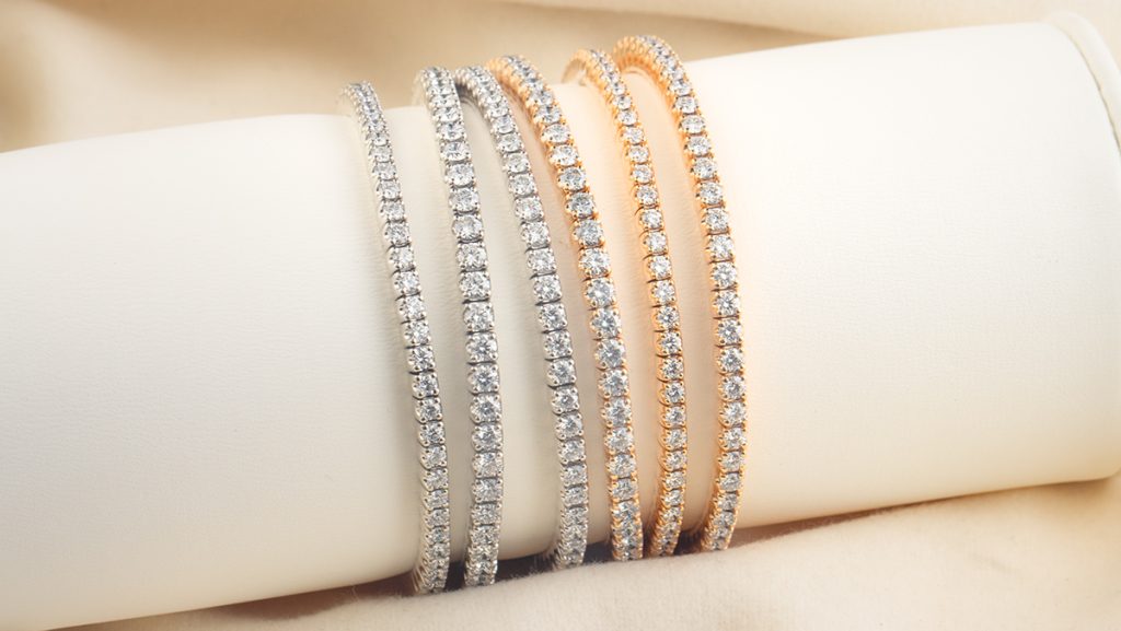 Jeweils drei silberne und goldene Tennisarmbänder nebeneinander