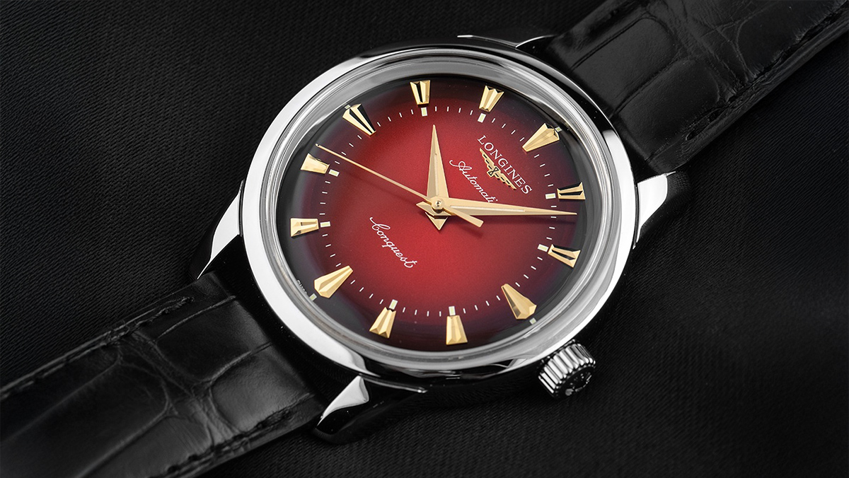 Longines Armbanduhr mit rot verlaufendem Zifferblatt und schwarzem Lederband